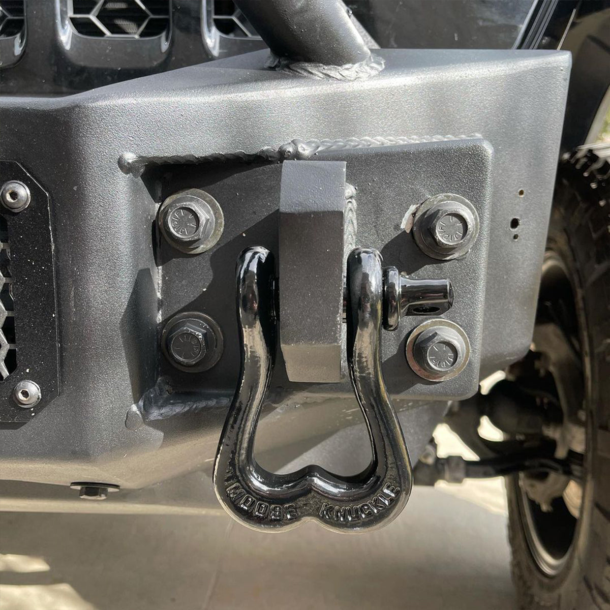 Black Jeep Recovery Shackle on the front of a Wrangler JK custom bumper shackle mount