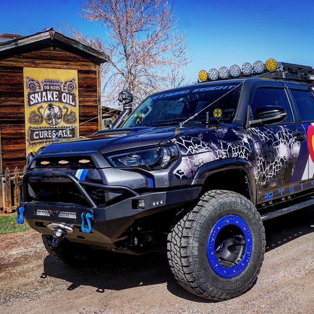 Blue Tow Shackles on the front bumper of a toyota 4runner lighted front bumper