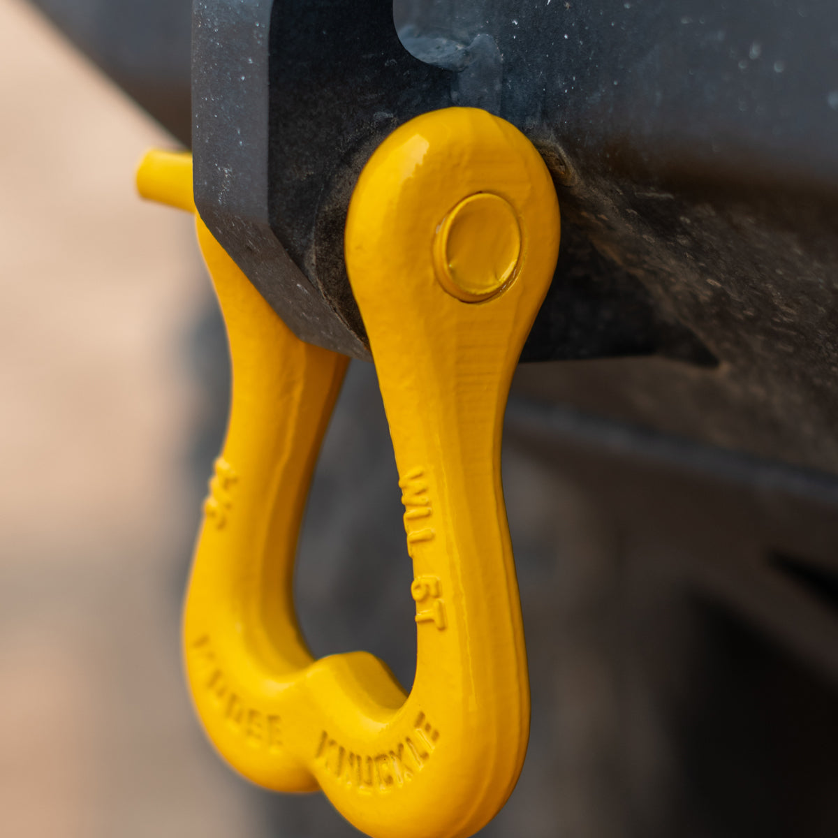 Yellow Jeep truck shackle on a custom rear bumper